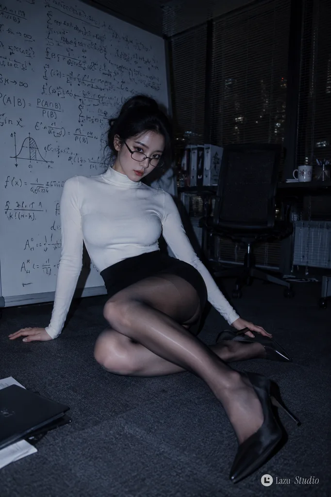 Cool-toned direct-flash portrait of a woman in office wear before a whiteboard.