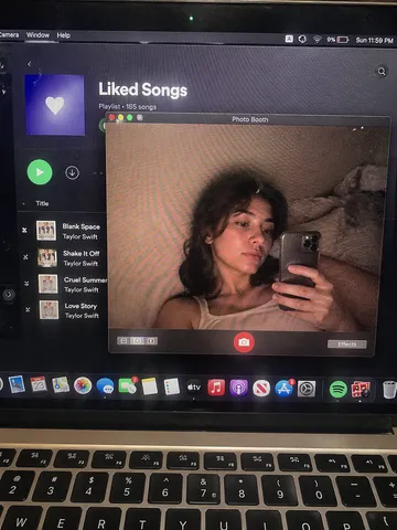 Top-down view of a laptop screen showing a Photo Booth camera window with subtle pixel texture.