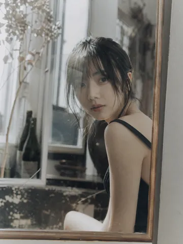 Japanese idol looking directly forward through layered glass reflections in a vintage negative film style.
