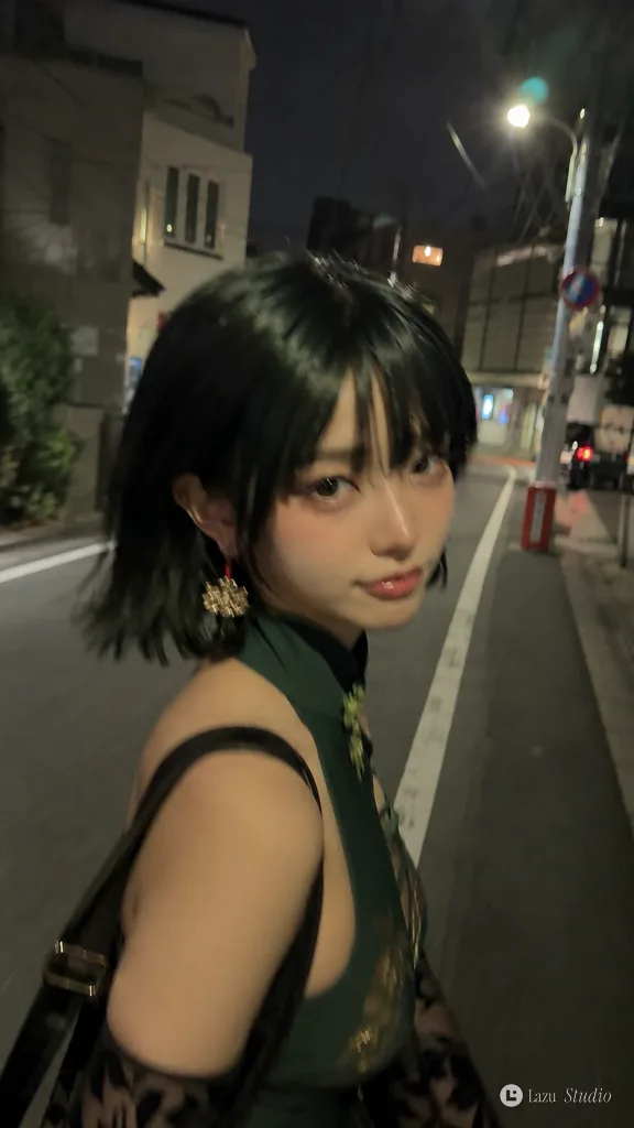 A casual motion-blurred selfie of a person walking down a city street at night under warm streetlights.