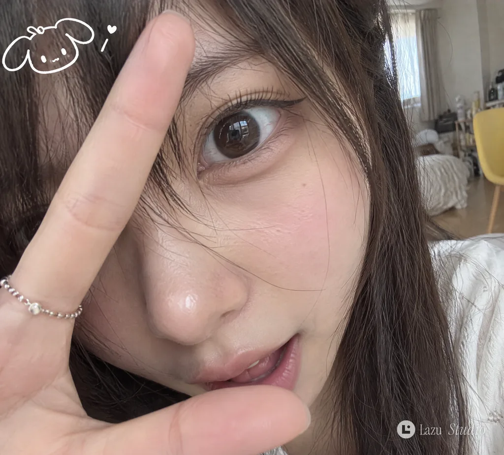Extreme close-up selfie of a woman with one large eye, cheek, and hand framing her face.